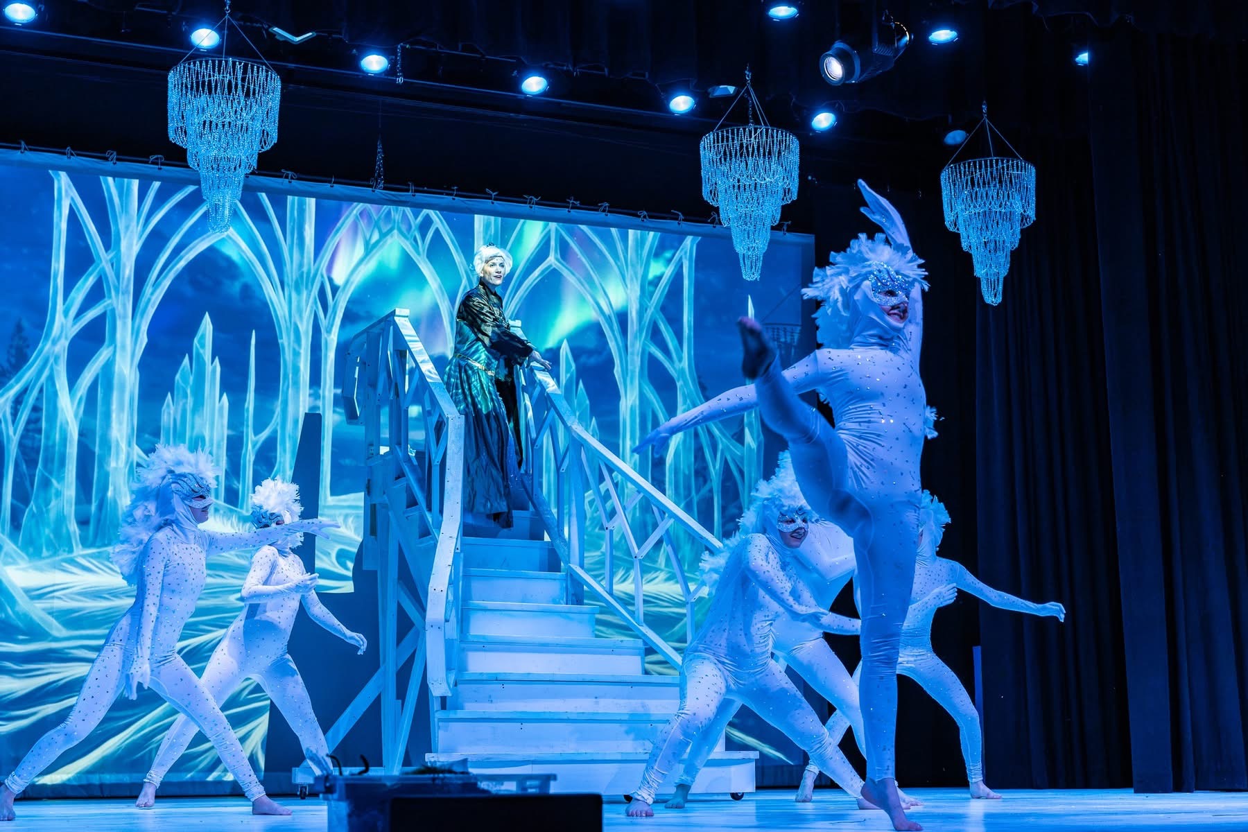 Elsa and the snow chorus performing before Nick Carr Studio's projected ice-palace environment