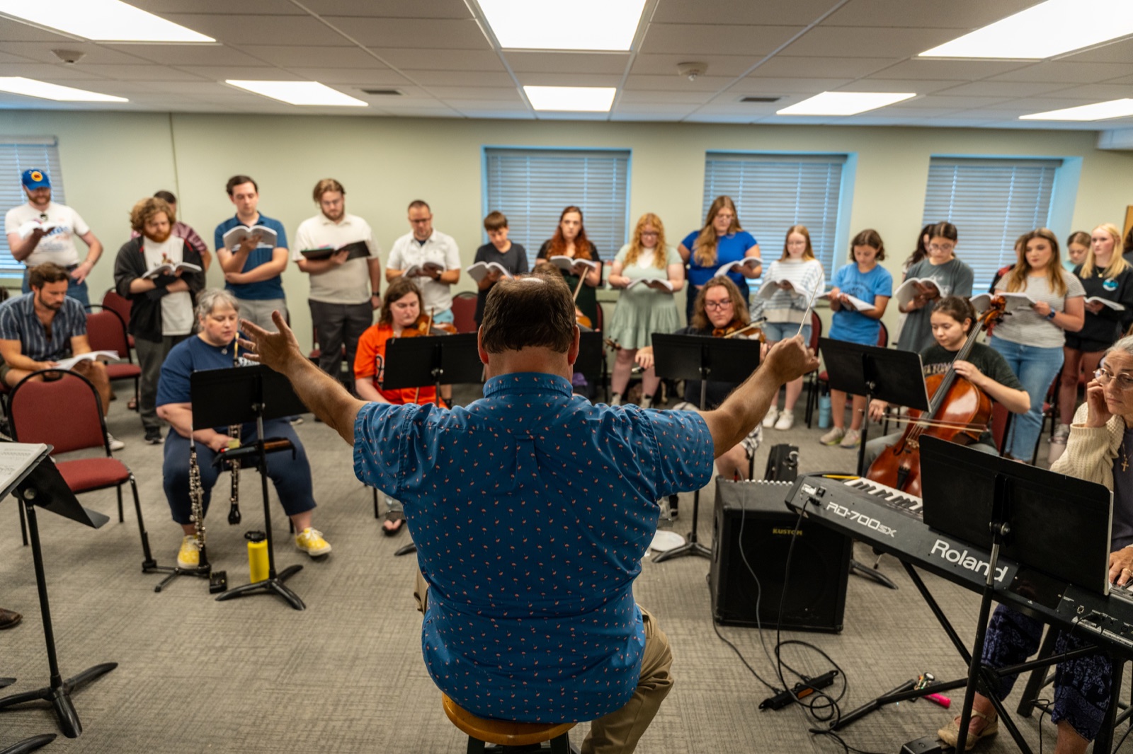 Cast, orchestra, and music director rehearsing Frozen the Broadway Musical together